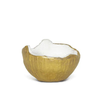 Textured gold metal bowl with a white interior and organic, uneven rim.