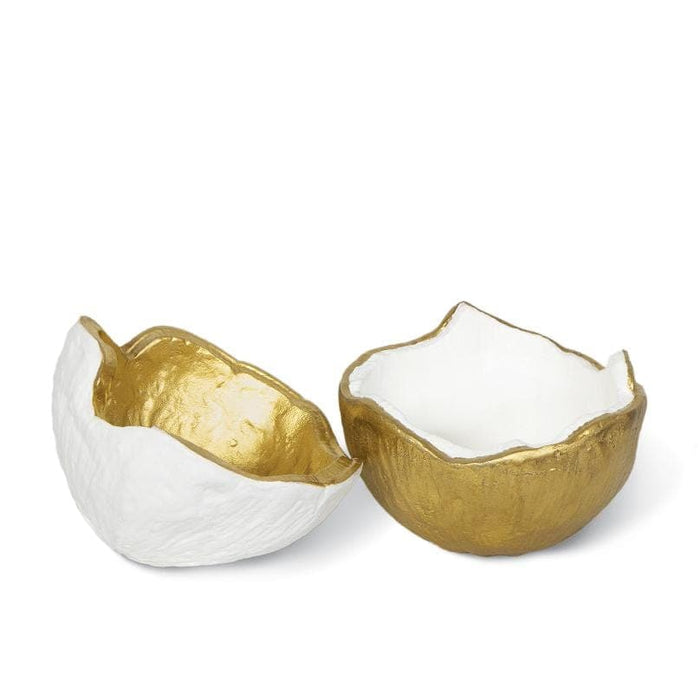 Two textured metal bowls, one white with a gold interior, the other gold with a white interior.