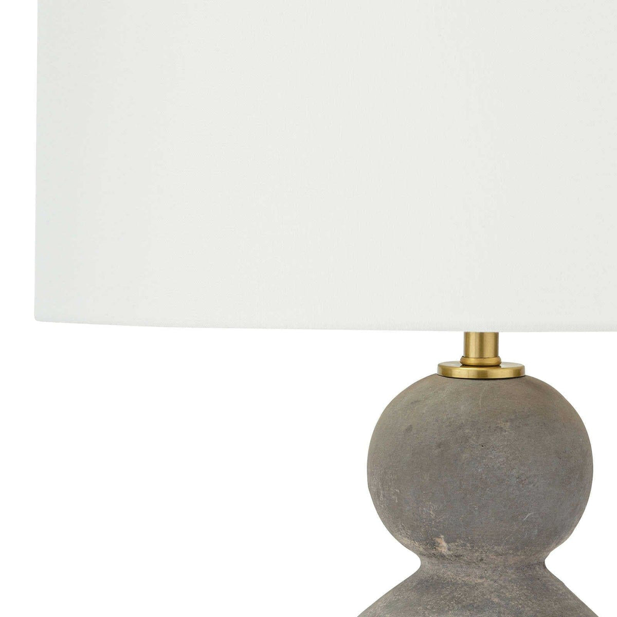 Playa ceramic table lamp with an organic gray glaze, brass accents, and a crisp natural linen drum shade.