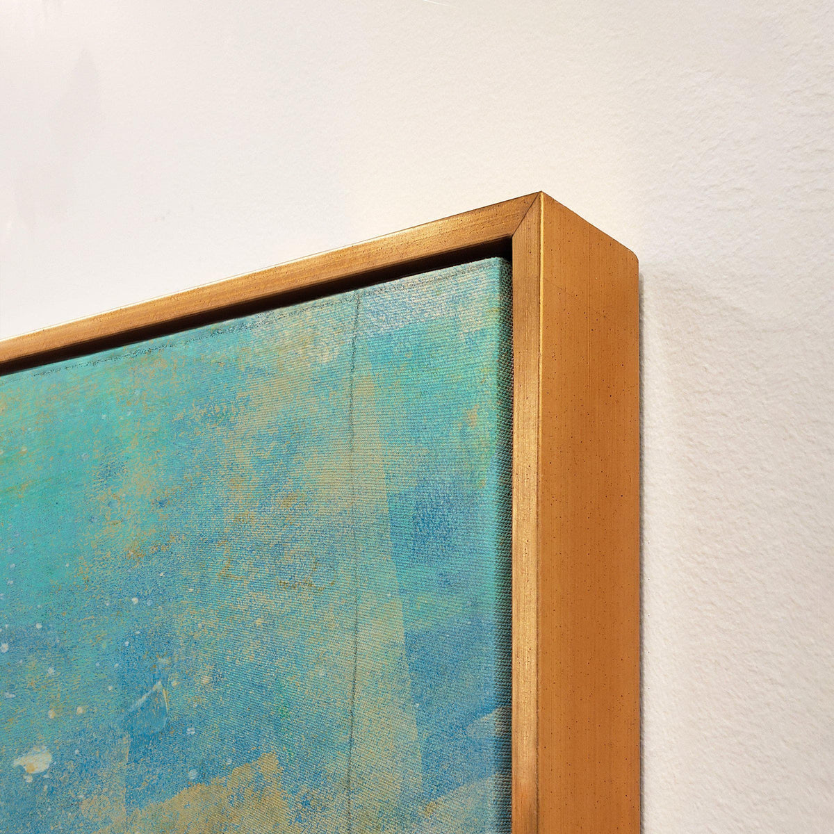 Close-up of a giclee canvas painting with textured blue and gold abstract art in a gold frame.