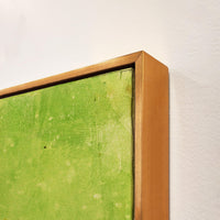 Close-up of a green giclee canvas painting with knife gel finish in a gold floating frame.