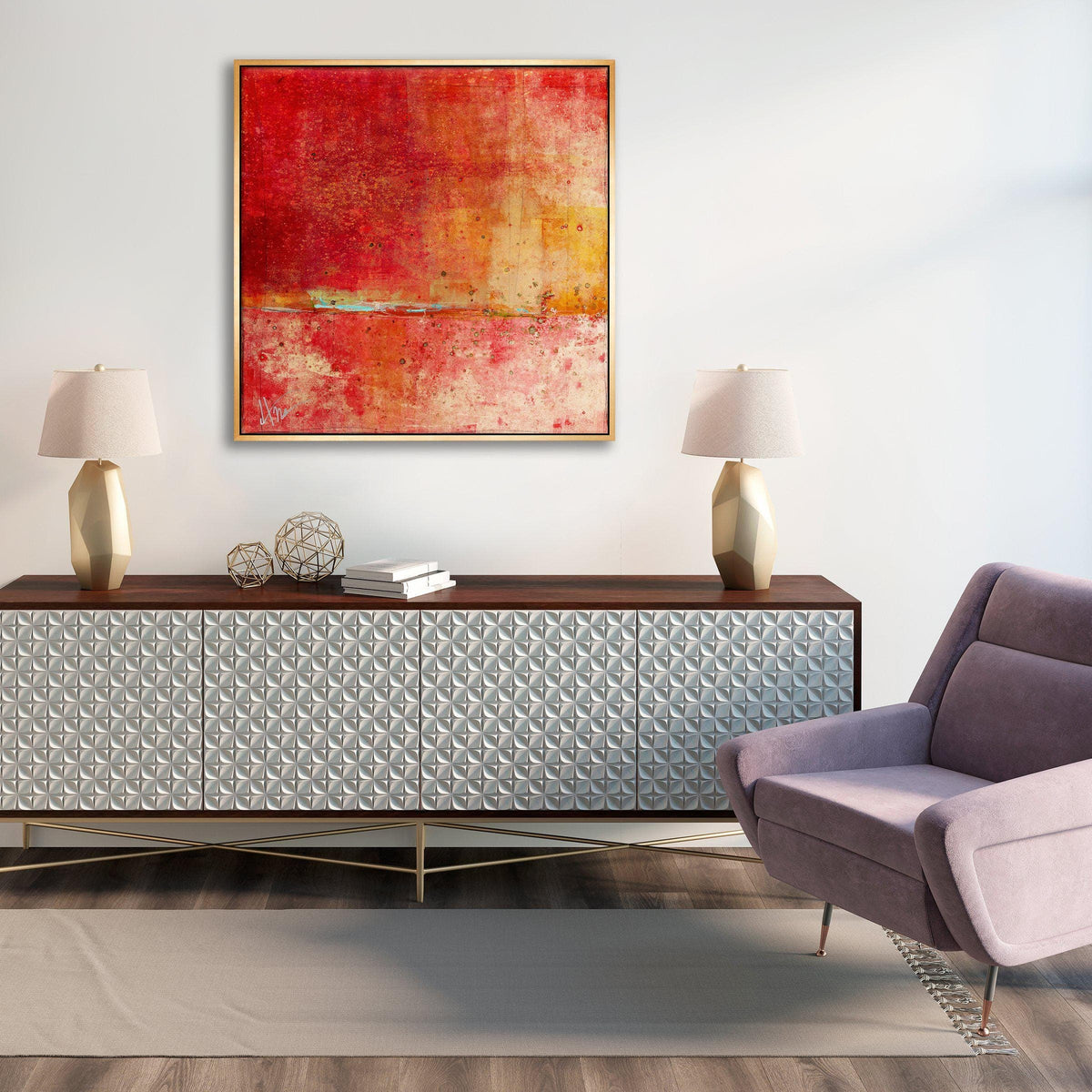 Abstract red and yellow giclee canvas painting with a gold frame above a modern console table and lavender armchair.