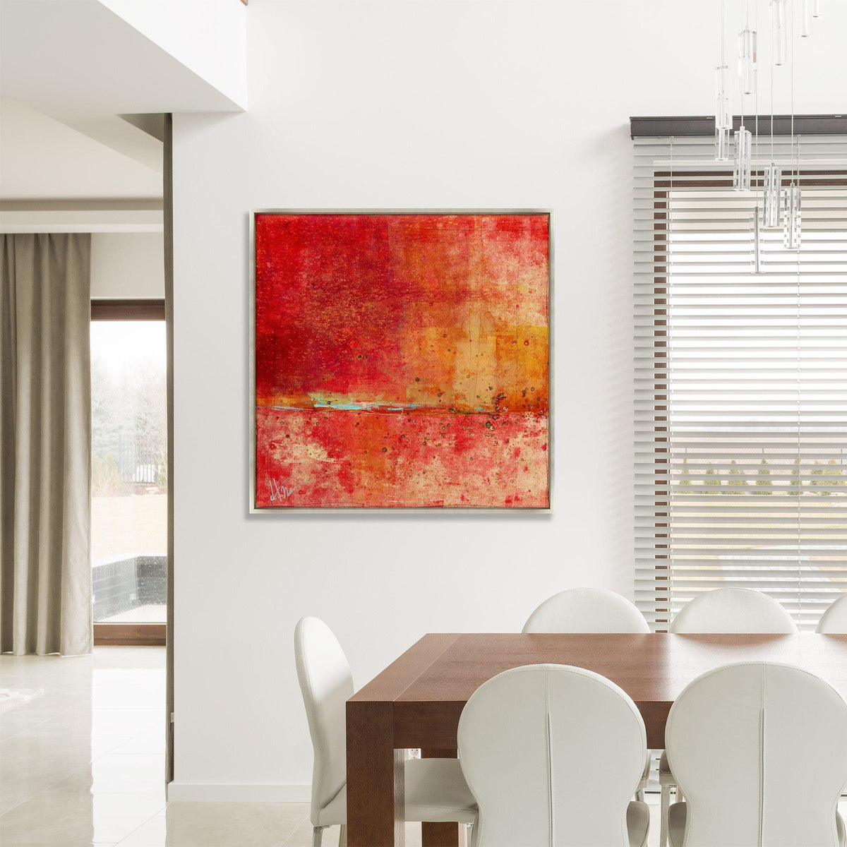 Abstract red and orange giclee canvas painting with a knife gel finish, framed above a dining table.