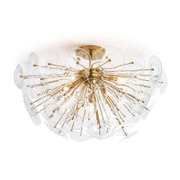 Poppy semi-flush mount light with clear undulating glass discs and natural brass rods.