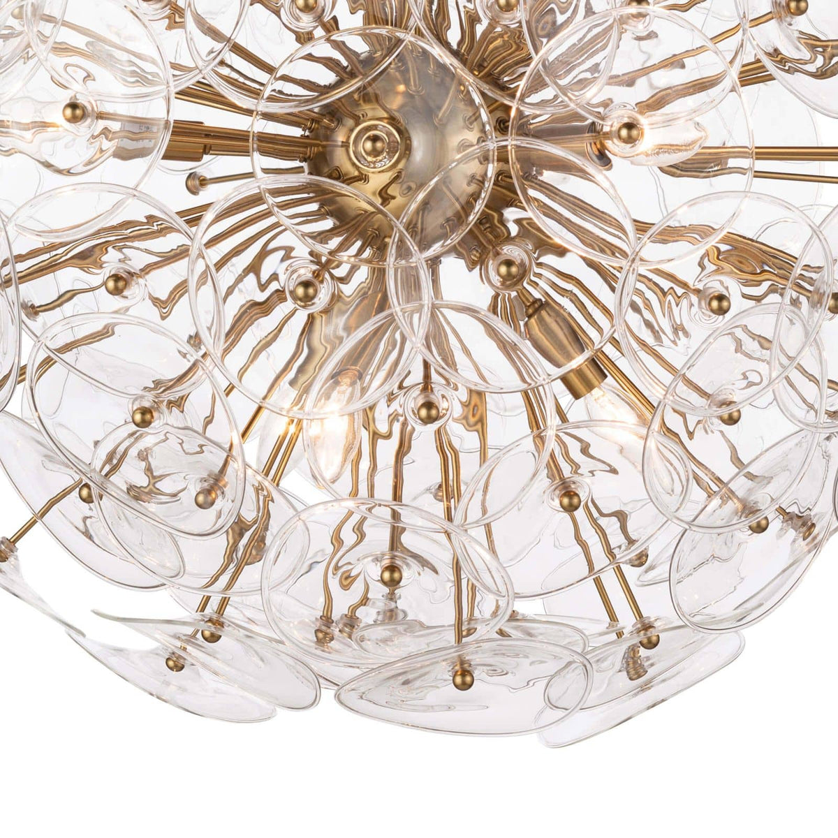 Poppy sputnik-style chandelier with clear undulating glass discs and natural brass rods.
