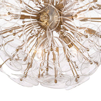 Poppy sputnik-style chandelier with clear undulating glass discs and natural brass rods.