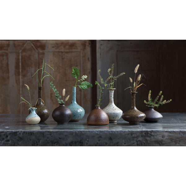 Set of 8 eclectic porcelain bud vases in varying shapes, sizes, and colors like robin's egg blue and warm browns.