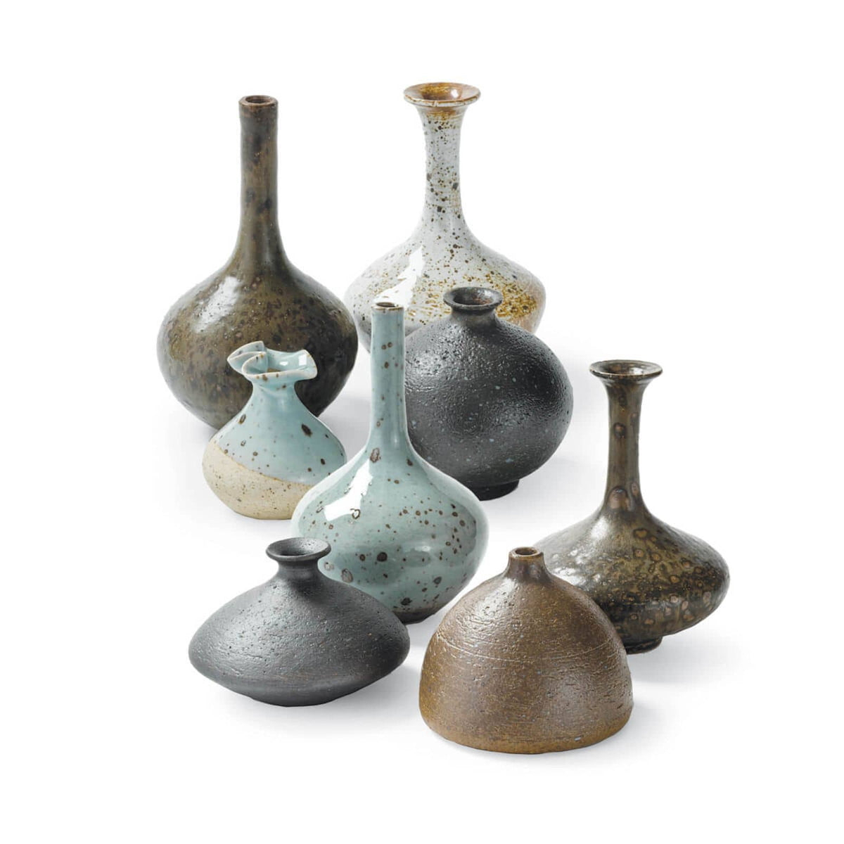 Set of 8 eclectic porcelain bud vases in varying shapes, sizes, and colors like robin's egg blue and warm browns.
