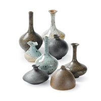 Set of 8 eclectic porcelain bud vases in varying shapes, sizes, and colors like robin's egg blue and warm browns.