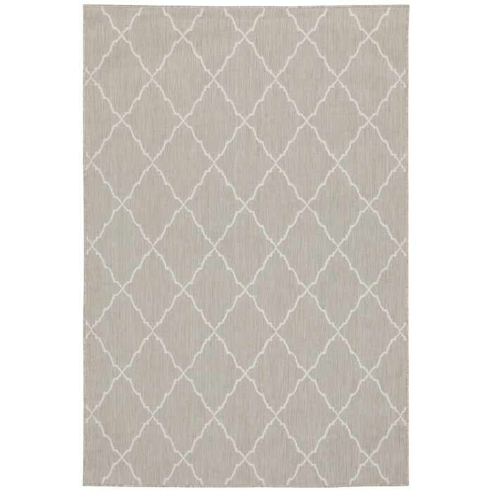 Portofino Grey flatwoven polypropylene outdoor rug with a white geometric trellis pattern.