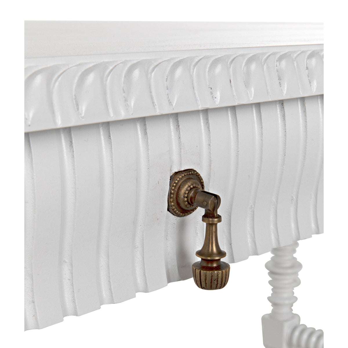 Close-up of a Portuguese white office desk with carved apron, spool-turned leg, and antique brass drawer pull.