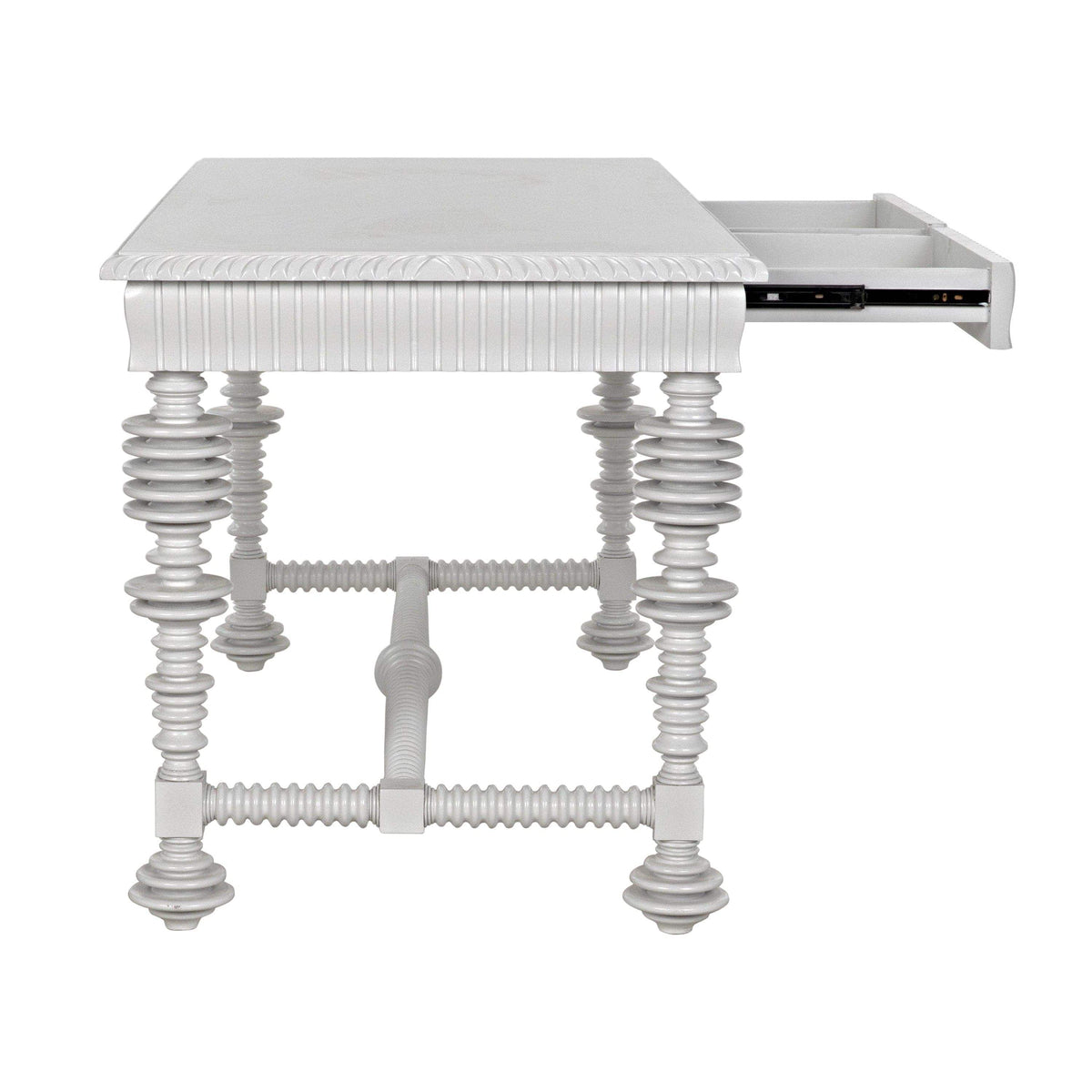 White mahogany office desk with spool-turned legs, carved apron, and an open drawer.