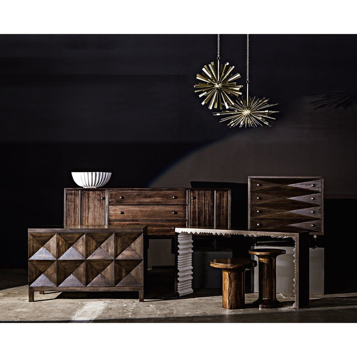 Ebony walnut sideboard with two geometrically carved doors, a white bowl, and other dark wood furniture.