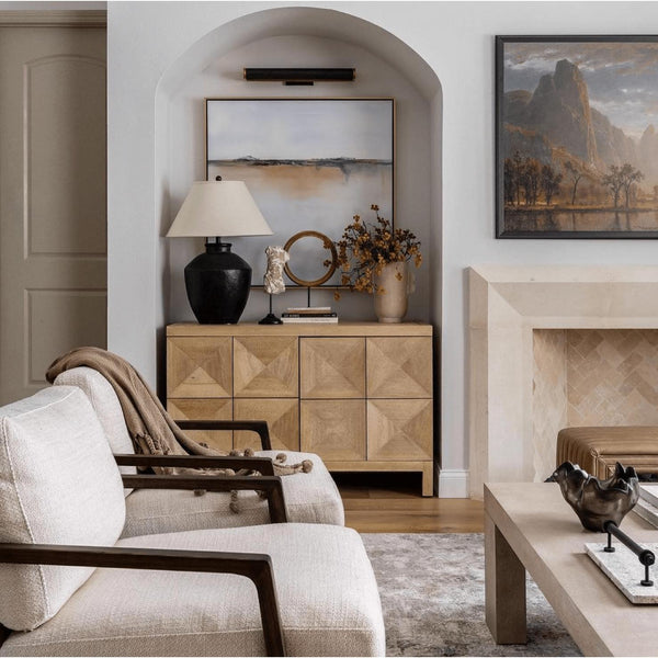 Washed walnut Quadrant 2-door sideboard with geometric carved doors in a living room setting.
