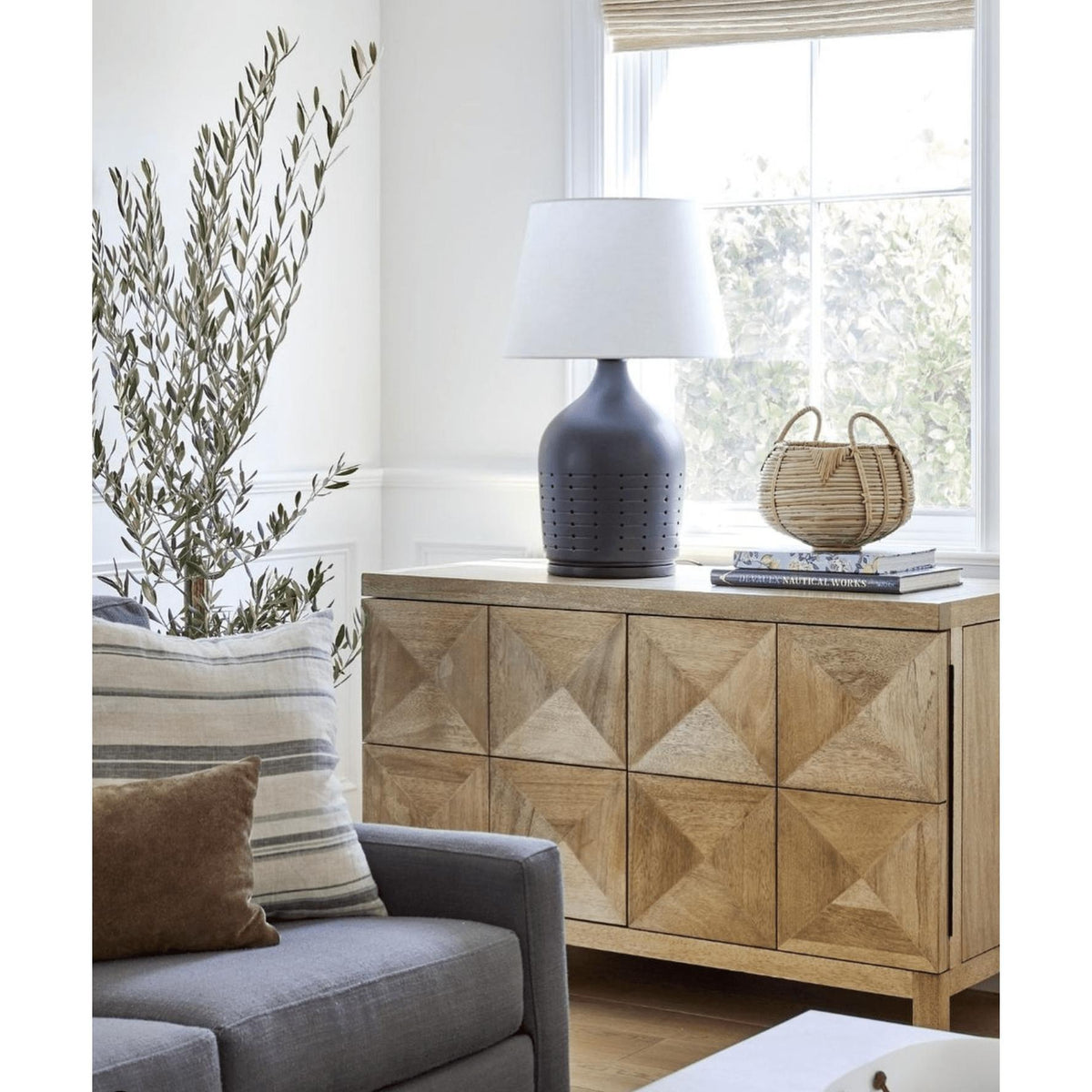 Washed walnut sideboard with two geometrically carved doors, featuring a smooth finish.