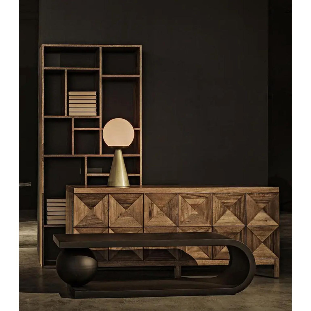 Dark walnut sideboard with three geometrically carved doors, a modern lamp, and a bookshelf.
