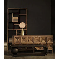 Dark walnut sideboard with three geometrically carved doors, a modern lamp, and a bookshelf.