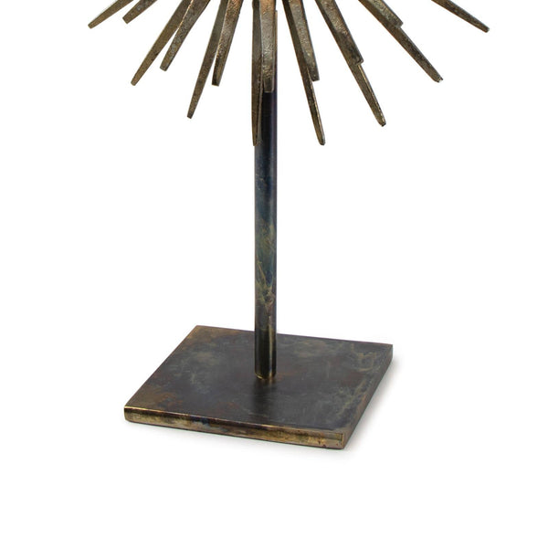 Radiant Sculpture: Industrial-chic patinated iron base with spiked mirror surround.