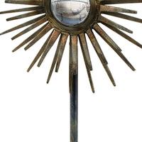 Radiant Sculpture: Industrial-chic patinated iron base with a spiked surround and convex mirror.