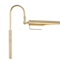 Close-up of a Raven floor lamp with a polished nickel finish, featuring an adjustable, bird-like shade.
