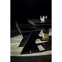 Black mahogany dining table with rectangular lines and brass leg bands, next to a matching chair.