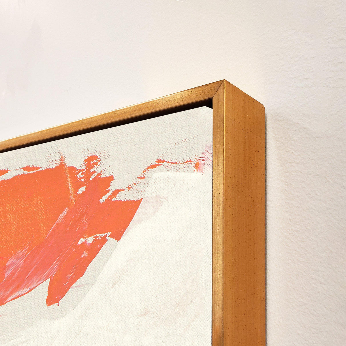 Close-up of Reef I Giclee Canvas Painting with vibrant orange brushstrokes on white, framed in gold.