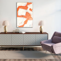 Reef I Giclee Canvas Painting, a vertical abstract artwork with orange and white brushstrokes, framed above a console.