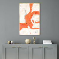 Reef II Giclee Canvas Painting: abstract orange, white, and black brushstrokes in a gold frame above a gray cabinet.