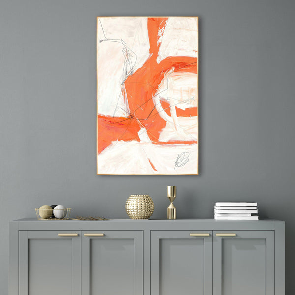 Reef II Giclee Canvas Painting: abstract orange, white, and black brushstrokes in a gold frame above a gray cabinet.