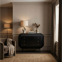 Black mahogany Rhiana vanity dresser with angled edges, tall slim legs, and three drawers.