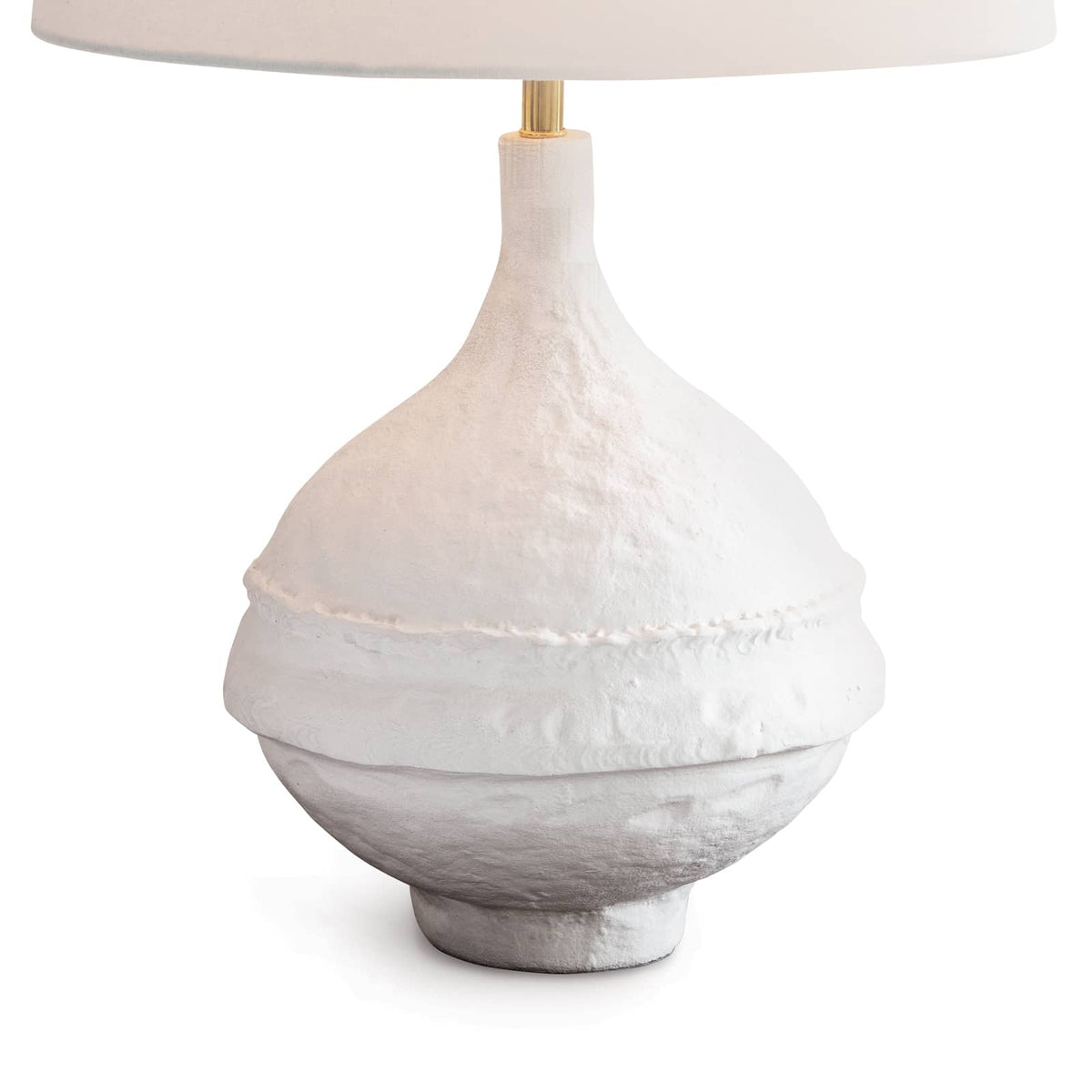 Riviera Table Lamp with a matte white, textured paper mache-inspired base and a light linen shade.