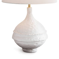 Riviera Table Lamp with a matte white, textured paper mache-inspired base and a light linen shade.