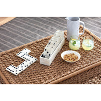 Royal Dominos Set with white bone pieces and an inlaid bone mosaic case on a woven table.