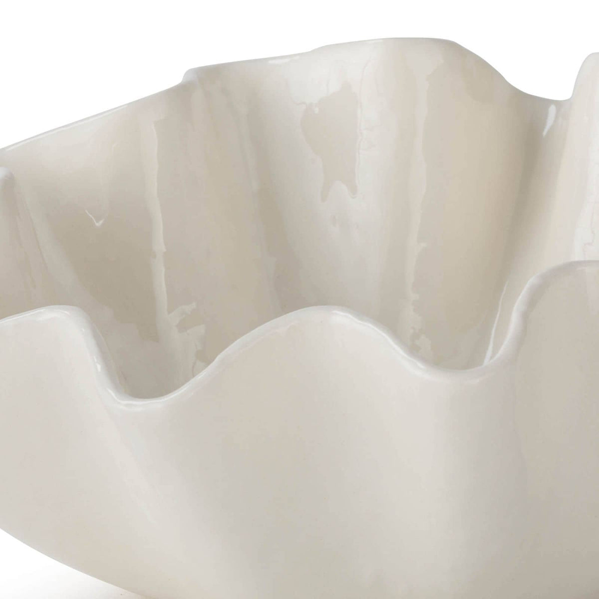 Large creamy white ceramic bowl with ruffled edges.