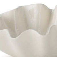 Large creamy white ceramic bowl with ruffled edges.