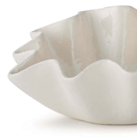 Medium creamy white ceramic bowl with ruffled, wavy edges.