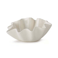 Medium creamy white ceramic bowl with ruffled edges.