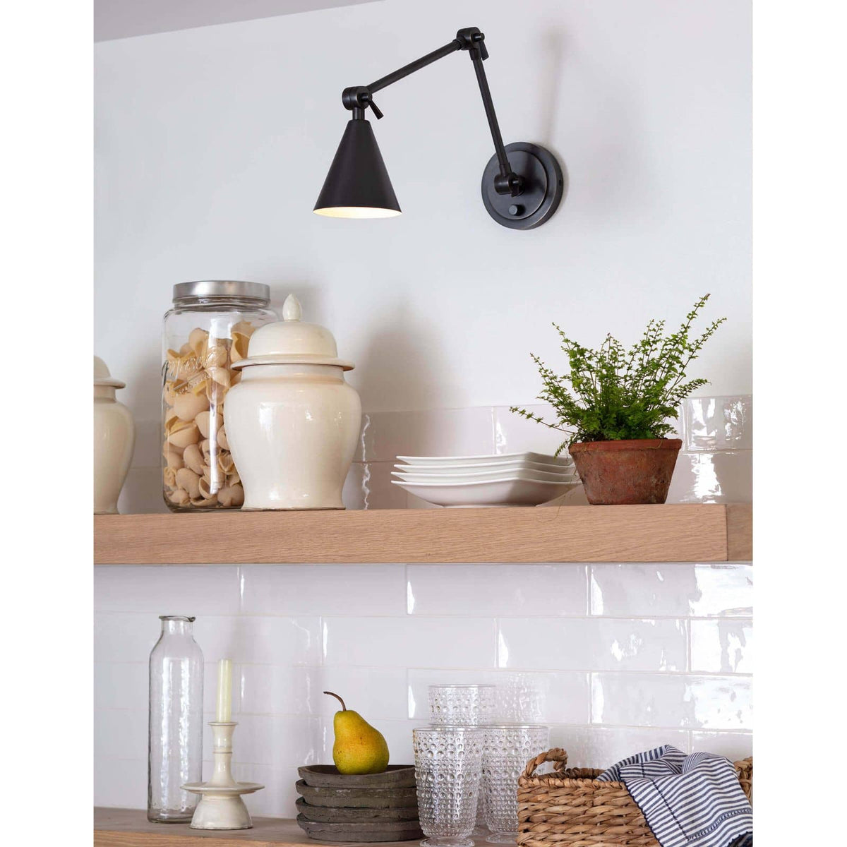 Sal Task Sconce in oil rubbed bronze, a Mid-Century Modern wall light with an adjustable arm and long tail.