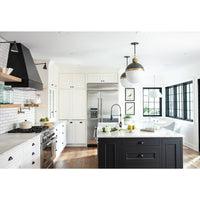 Modern kitchen with white cabinets, black island, stainless steel appliances, and two globe pendant lights.