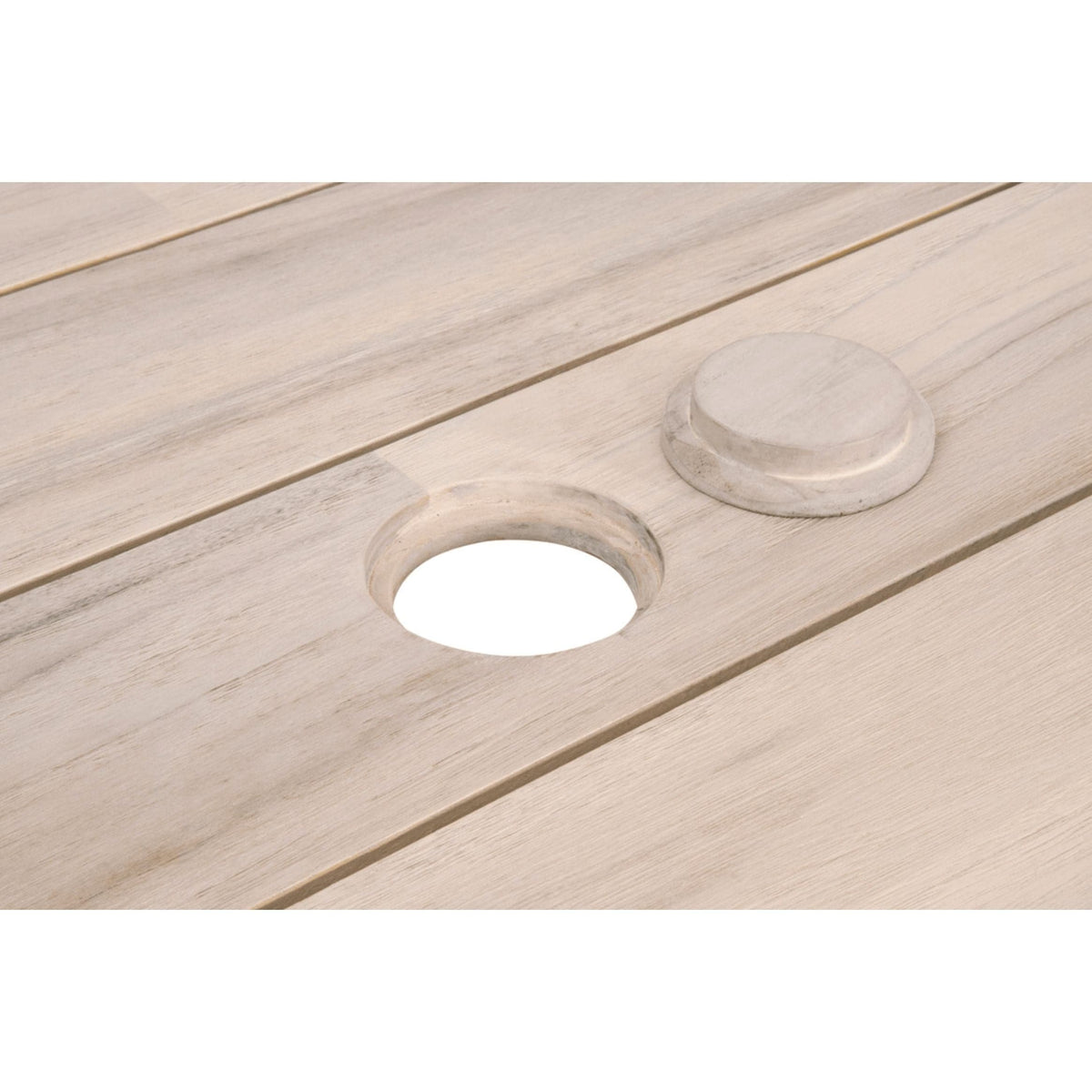 Close-up of a gray teak outdoor dining table with a round umbrella hole and matching cover.