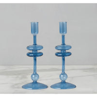 Pair of elegant 9"H sapphire blue glass candlesticks with stacked ring design on a marble surface.