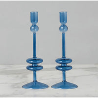 Pair of elegant sapphire blue glass candlesticks with unique stacked ring and sphere design.