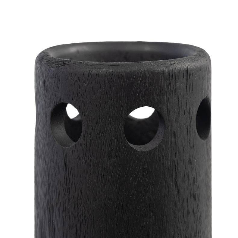 Close-up of a black wooden vase with a sleek silhouette and three circular cutouts.