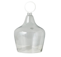 Clear glass decanter with a ring handle on a white background