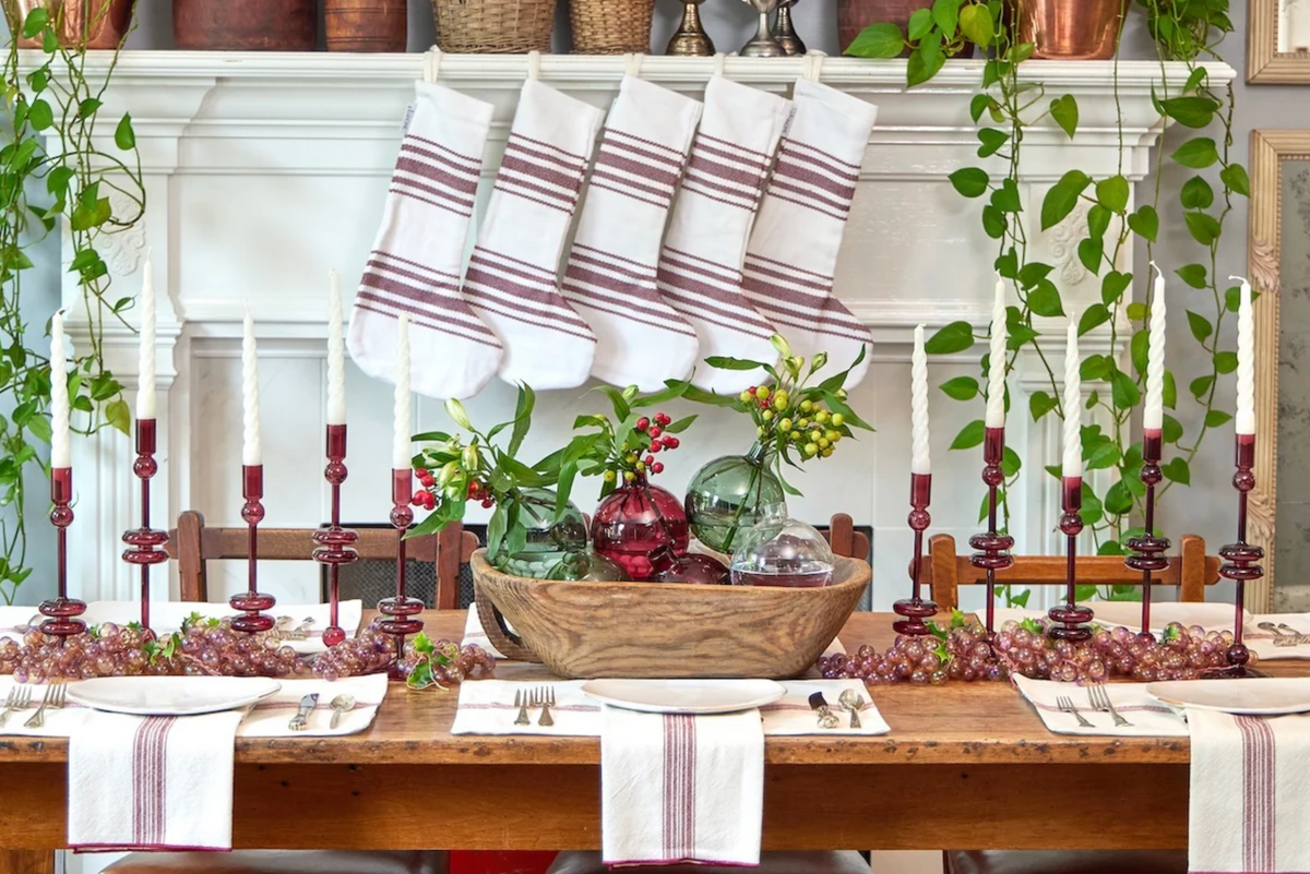 Dining table set for a meal with decorative items and striped table runners.