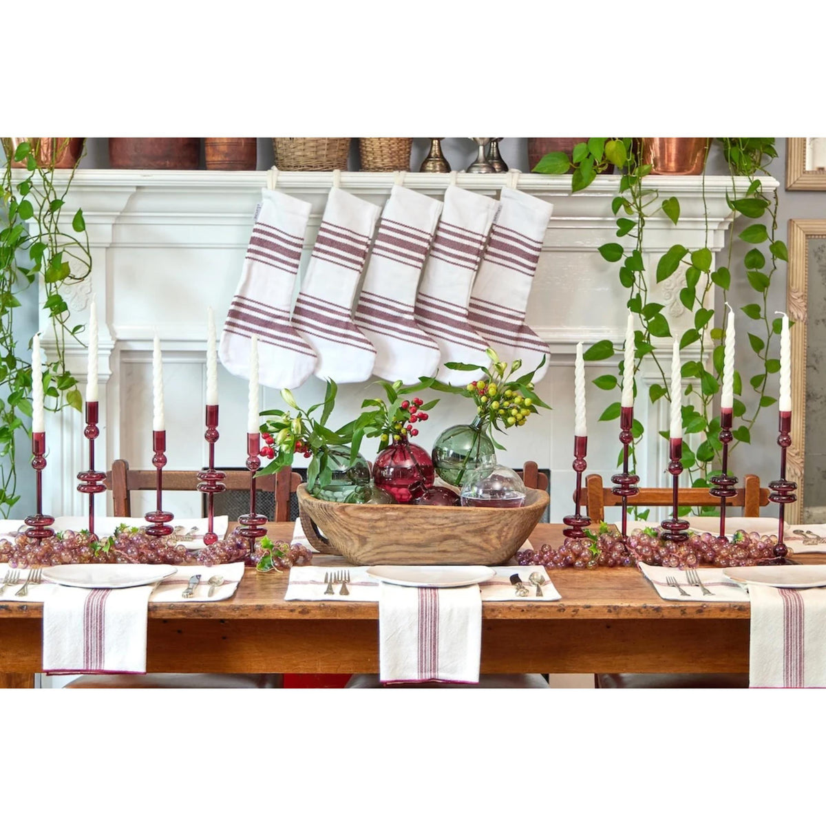 Dining table set for a meal with decorative items and striped table runners.