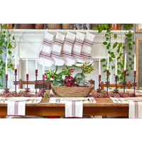 Dining table set for a meal with decorative items and striped table runners.