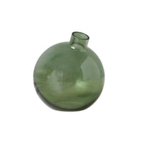 Green glass bud vase on a white surface with a white background