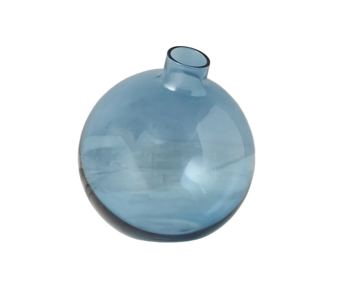 Blue glass vase on a white surface with a white background