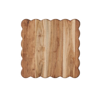 Wooden cutting board with scalloped edge on a white background